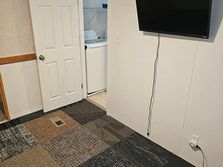 End bedroom with tv monitor included in rent.