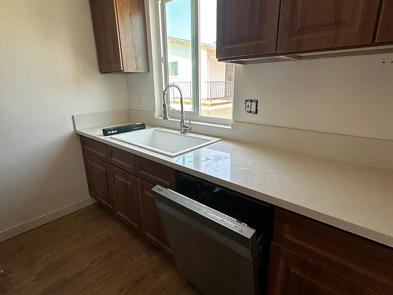 Renovated Kitchen with view from window over sink. Installed Blinds not shown in this photo