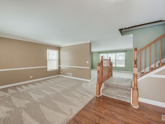 The foyer is open to the large living room, perfect for welcoming guests.