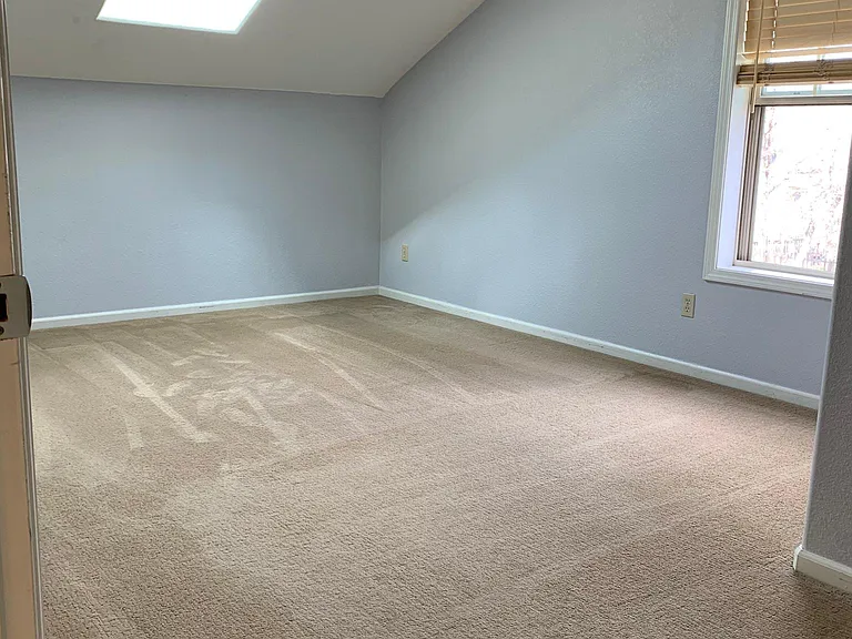 Large master bedroom w/new skylight and 2 Closets. Vacant pic.