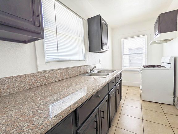Kitchen with stove and refrigerator