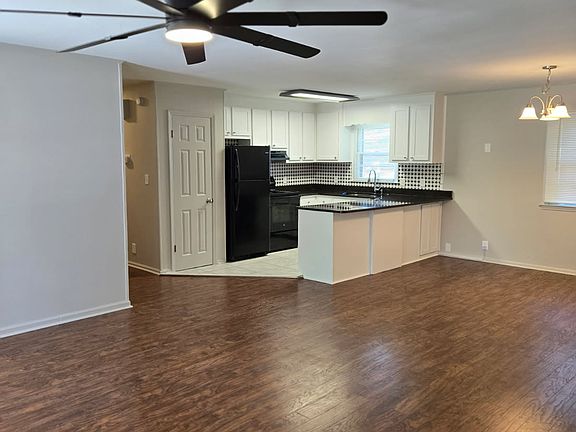 Kitchen With Granite Countertops and White Cabinets