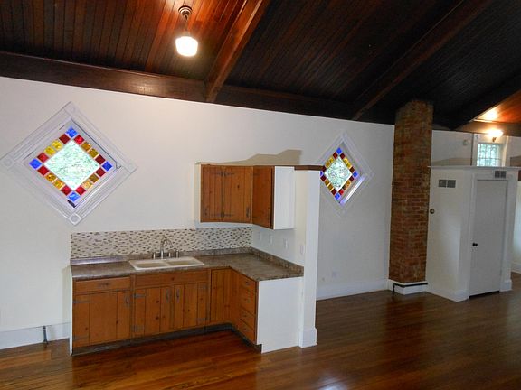 Lunch kitchen and cabinets. Eastern sun exposure through stain glass windows.