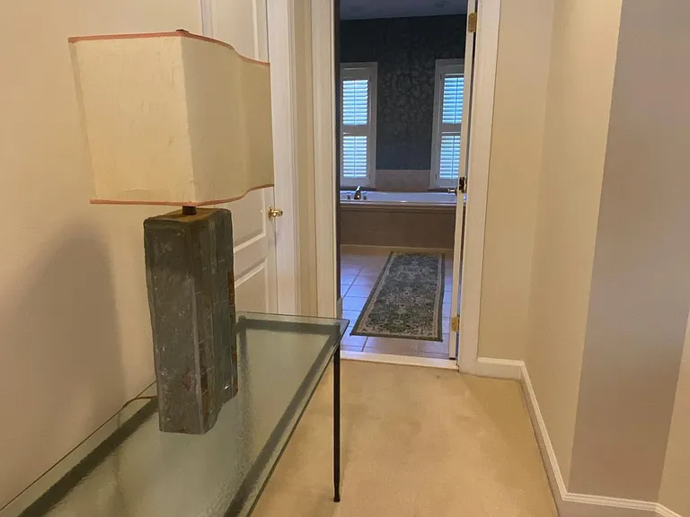 Walkway to walk in closets and primary bathroom
