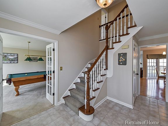 Open and bright foyer entrance with ceramic tile floor
