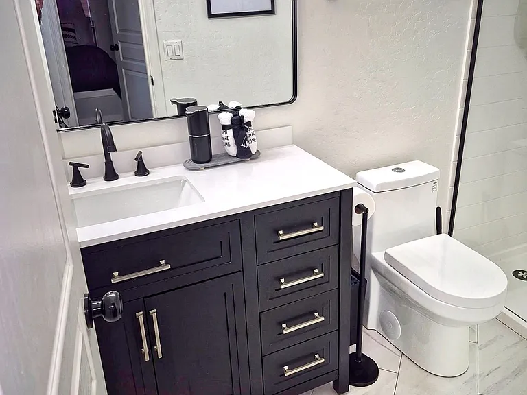Hallway bathroom near the 2nd and 3rd bedrooms. Completely remodeled with beautiful modern look. Eco-friendly toilet, new stone top vanity, new mirror, medicine cabinet, light fixtures, tile.