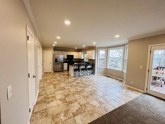 Kitchen with bar area and room for kitchen table.