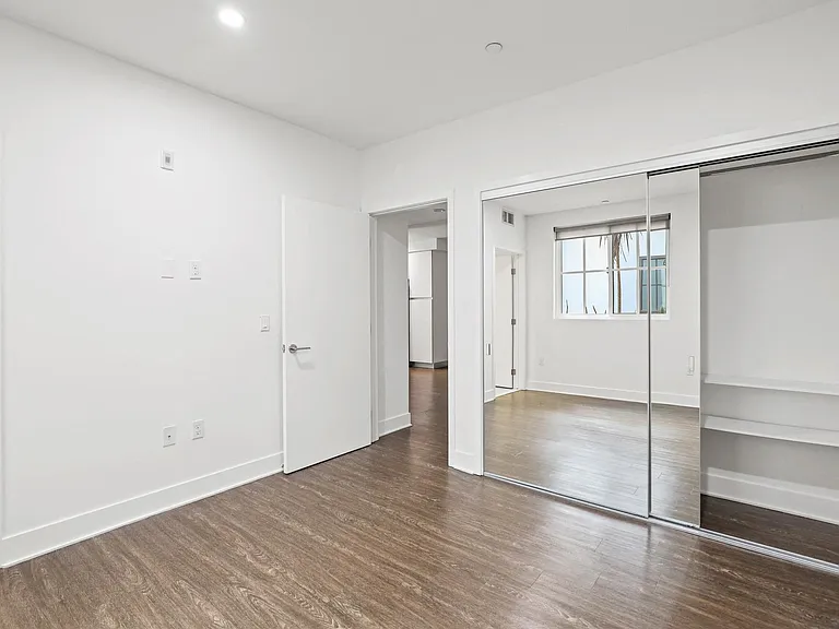 Bedroom with Mirrored Closet and Bathroom