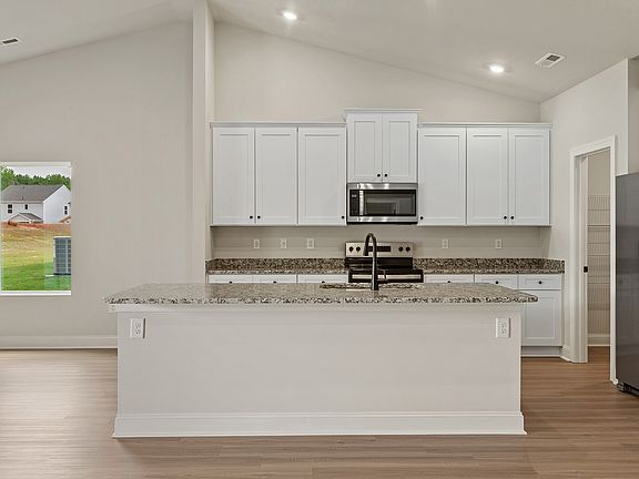The kitchen has wood cabinetry