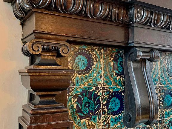 The massive fireplace of the music room features blue-green glazed art tiles. The PondsâEUR(tm) inventive