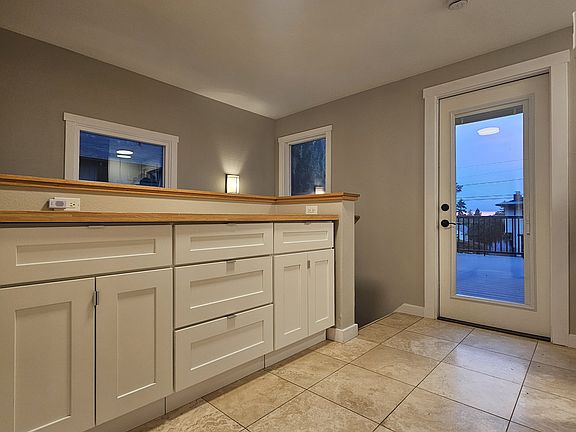 Extra storage off the kitchen with door access to deck.