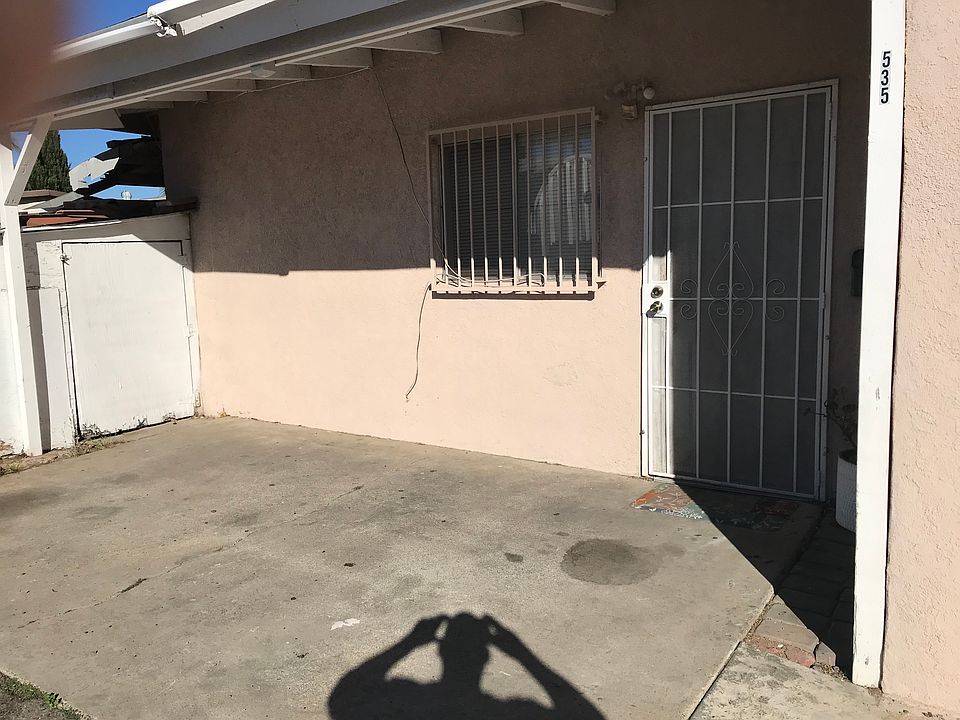 Outside parking and main entrance/ with storage shed on he side