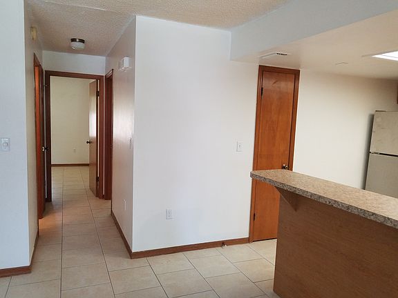 Kitchen with pantry closet on right of dining room. Hallway to 2 bedrooms and 2 baths.