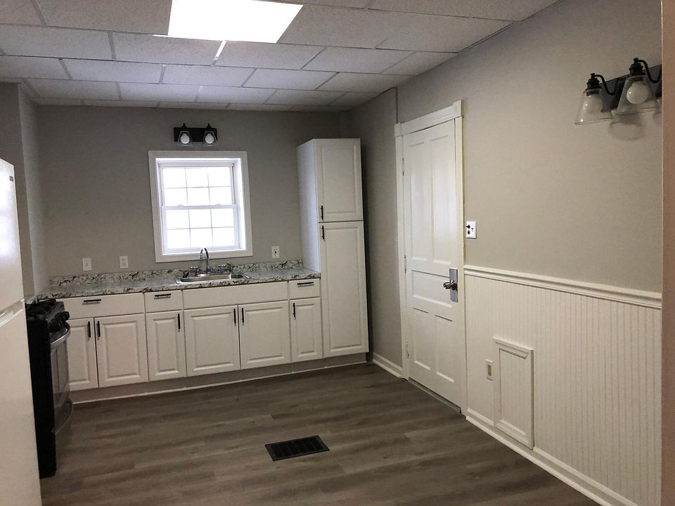Shelves going up alongside windows. Cabinets and pantry are new. Door accesses a mud room for extra storage