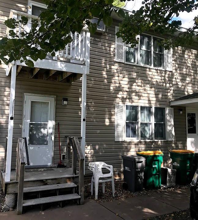 front entry to unit 1 on left. Shared entry on right. Garbage cans usually stored by garage. Sidewalk goes to street.