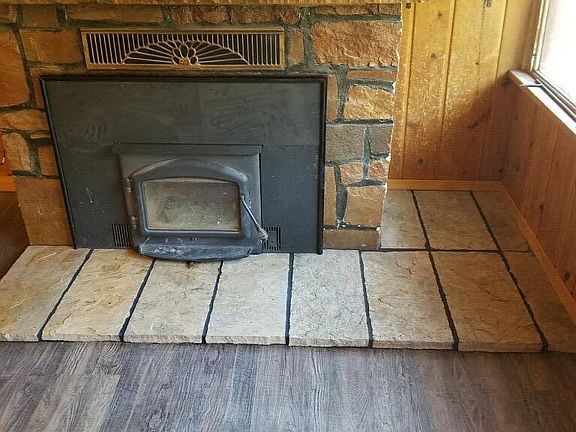 Wood stove with convenient interior wood bin.