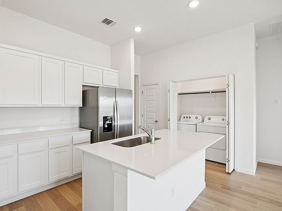 Kitchen in the Pinehurst home plan by Trophy Signature Homes - REPRESENTATIVE PHOTO