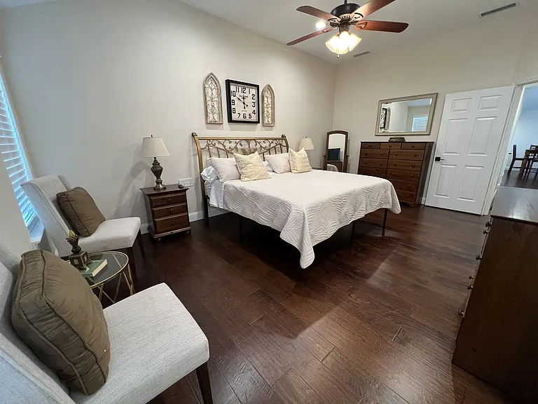 Spacious and relaxing primary bedroom retreat with elegant furnishings and vaulted ceilings
