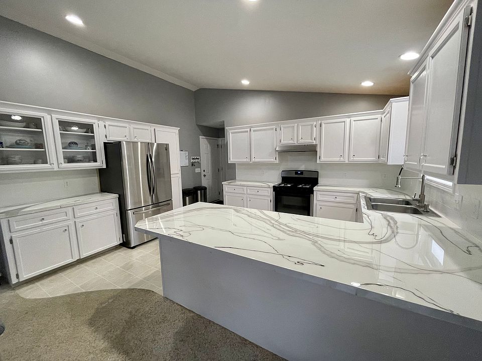 Remodeled kitchen with newer stainless steel appliances.