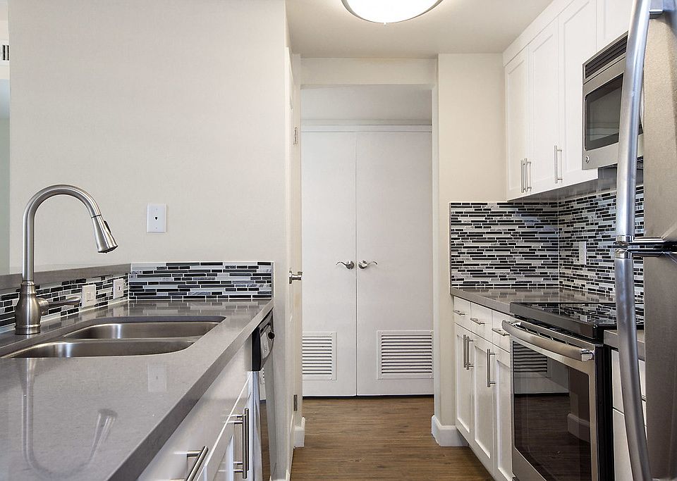 Kitchen with stainless steel appliances and a breakfast bar.