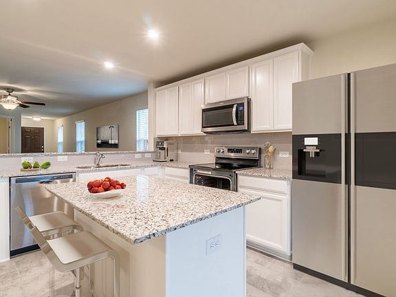 Model Representation - Spacious island kitchen with eat-in bartop and abundant cabinet space