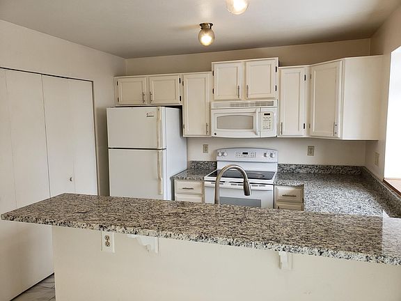 Updated kitchen with large dining bar in granite