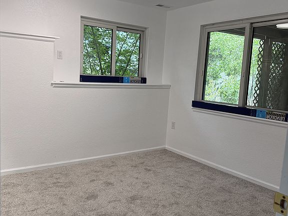 2nd bedroom with bulit-in shelf on west wall