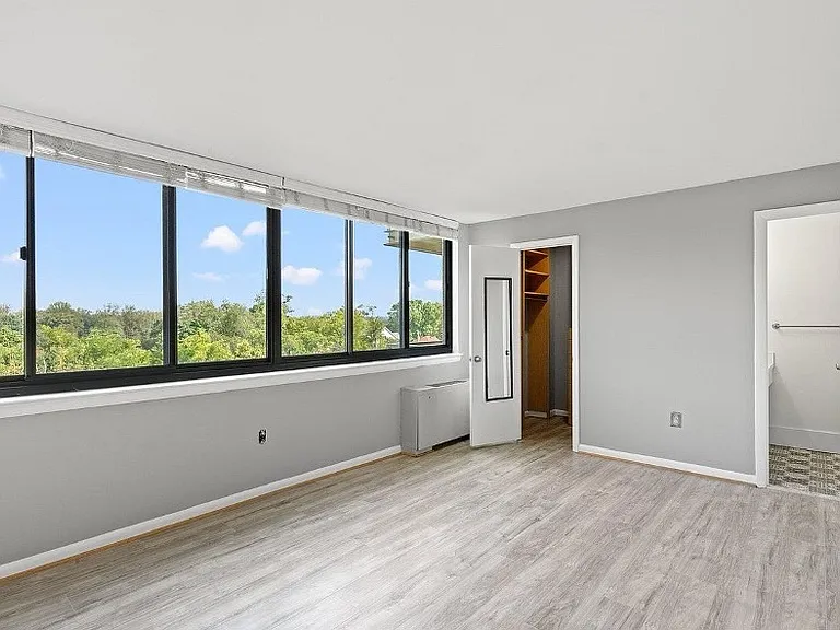 Primary bedroom with half-bath and walk-in closet