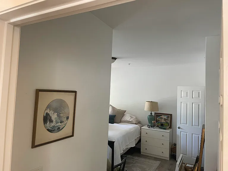 Entering the primary bedroom.
Door to the bathroom is open, and walk-in closet is just inside the door to the right.