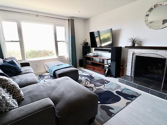Living room with hardware to hang TV & gas fireplace.