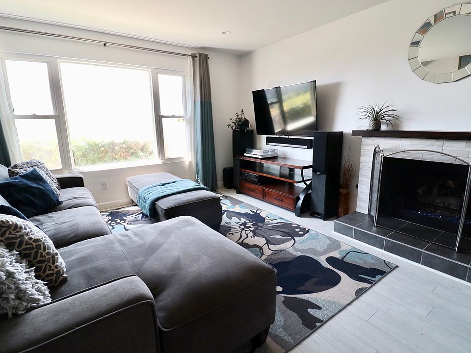Living room with hardware to hang TV & gas fireplace.