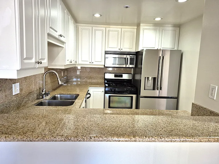 Updated kitchen with stainless appliances, granite counter top breakfast nook bar, cabinetry