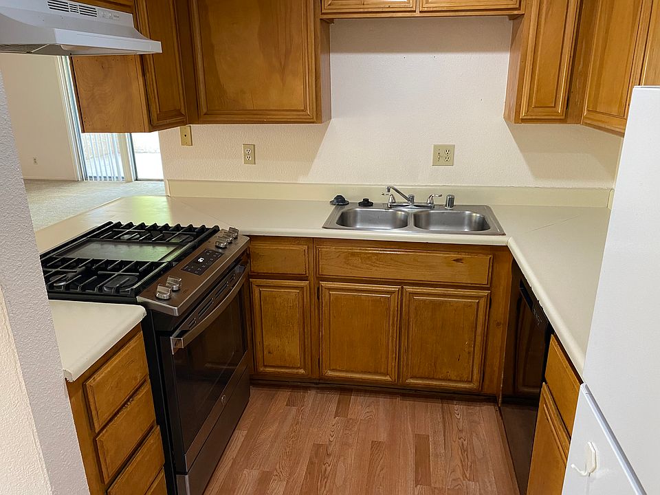 Large kitchen with new gas range, dishwasher and refrigerator.