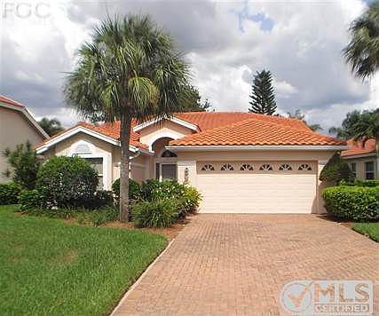 Front of Home with paver driveway and two car garage