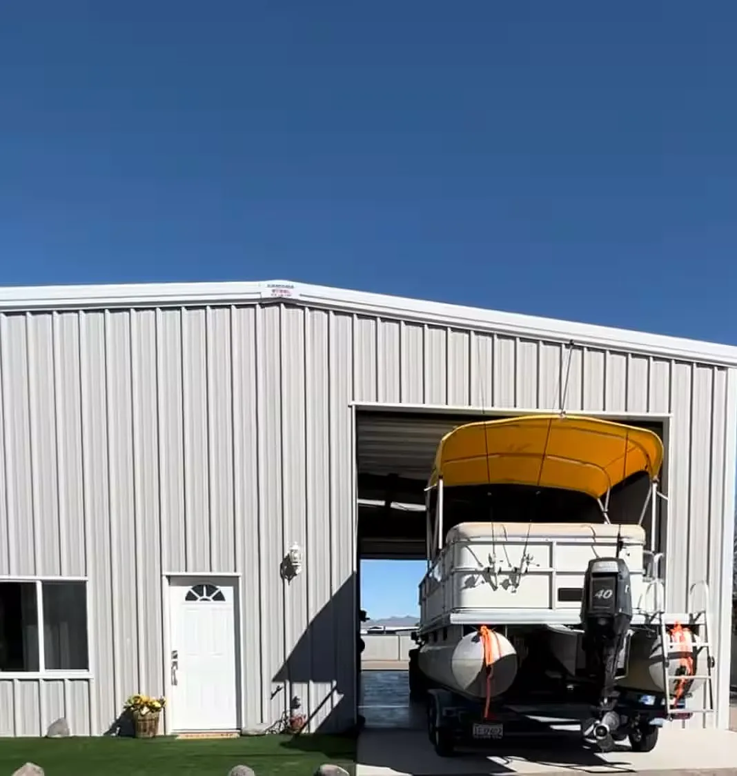 Exterior view of the oversized attached shop/garage with tall roll-up door and direct driveway access. - 1285 E Vacation Dr