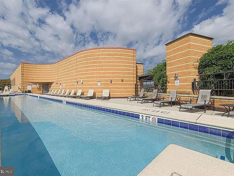 Rooftop pool with plenty of seating.