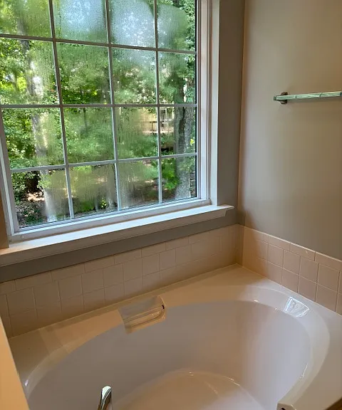 The window now features privacy blinds, which were installed after the photo was taken. Located on the second story and facing the backyard, this room is the most private and serene space in the house.