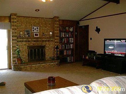 Large Den with wood burning fireplace.