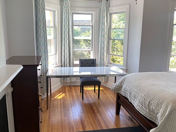 Upstairs master bedroom with natural light, hardwood floors and desk/study cove
