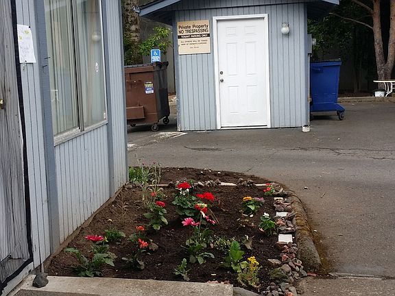 Tenants enjoy gardening by their doors