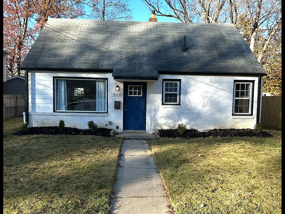 freshly painted brick house with new doors and windows