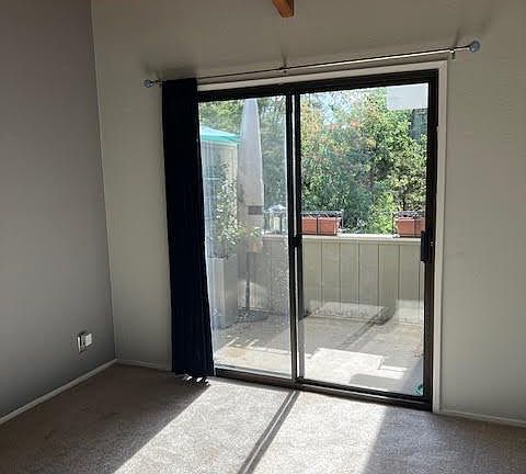 Sunny deck off bedroom with vaulted ceilings