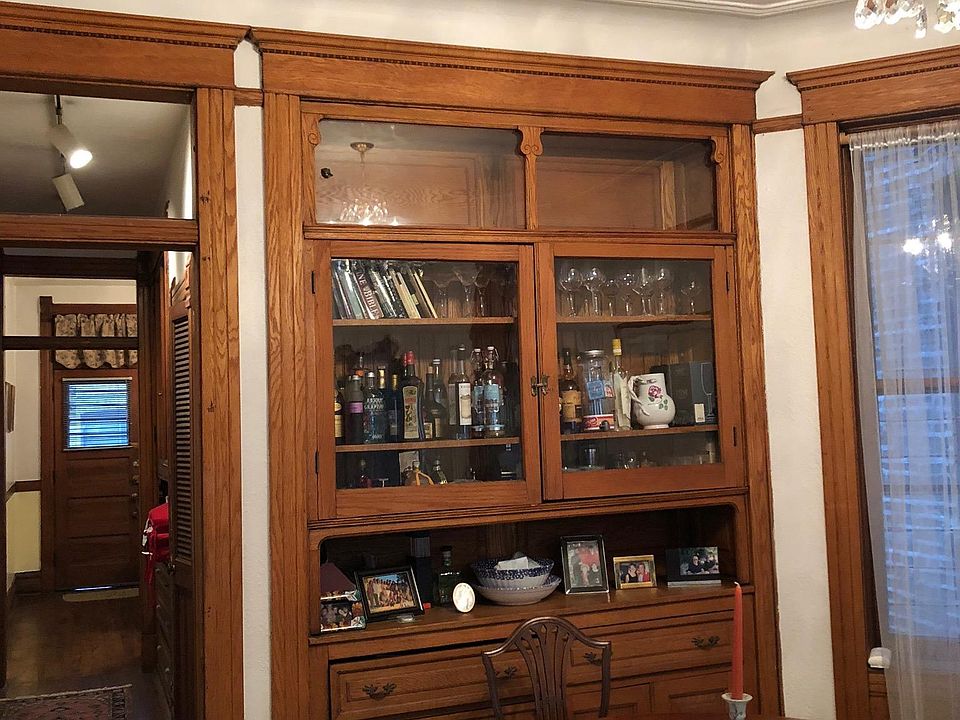 Dining room with built-in storage hutch and fine antique crystal chandelier