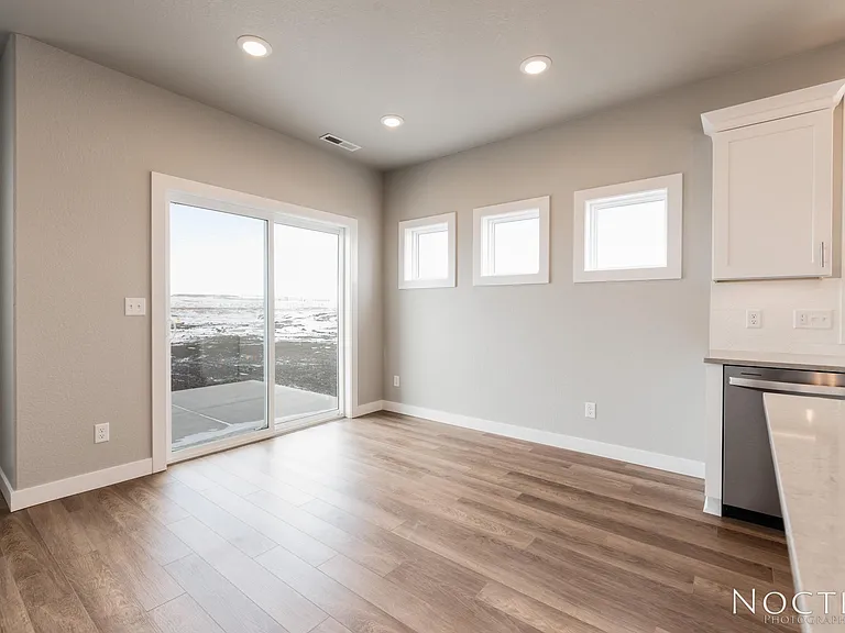 Beautiful dining area in an open living space. (Photo of another unit with similar finishes and quality.)