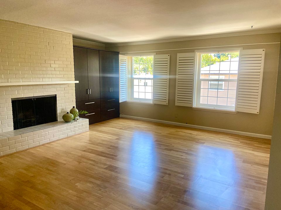 Living room w fireplace and wall storage cabinets