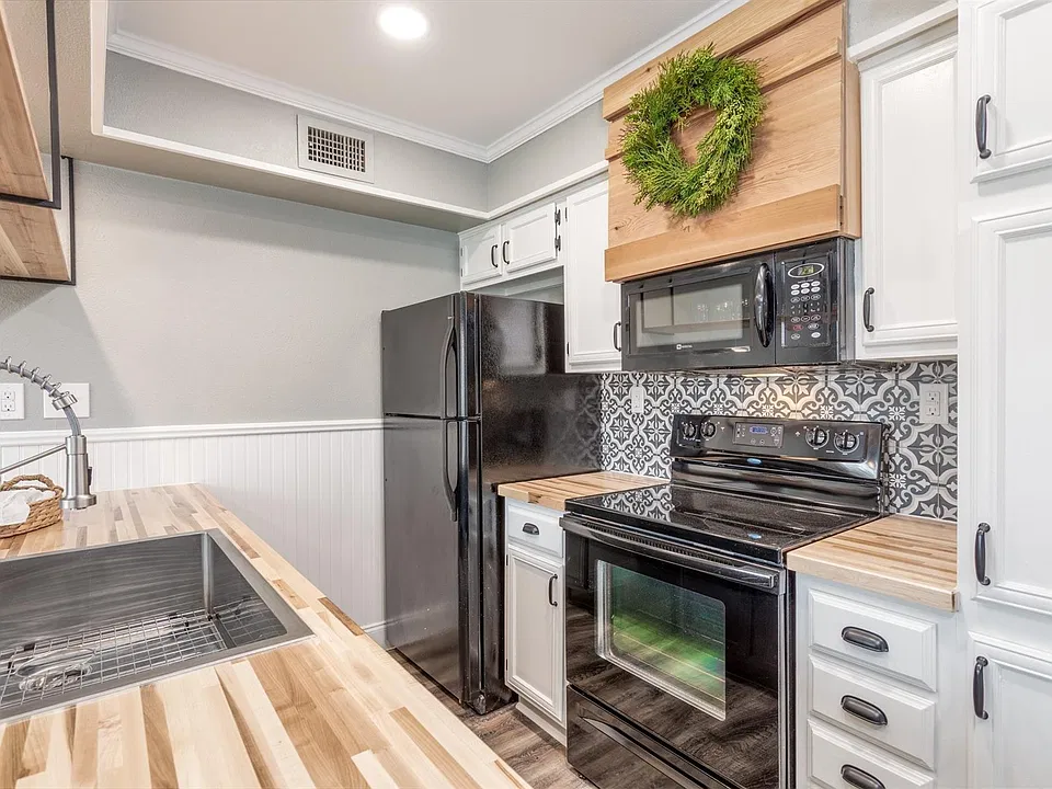 Butcherblock countertops, Electric Range, Microwave and Refrigerator included.