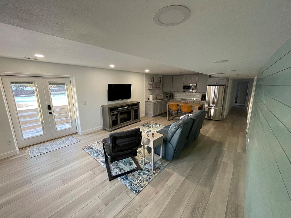 Living area showing private entrance and kitchen in back. Hallway to right leads to bedrooms. New LVP flooring on the entire floor of basement.
