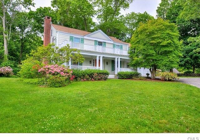 This charming Colonial is perched on a sloping hill in a desirable cul de sac location.
