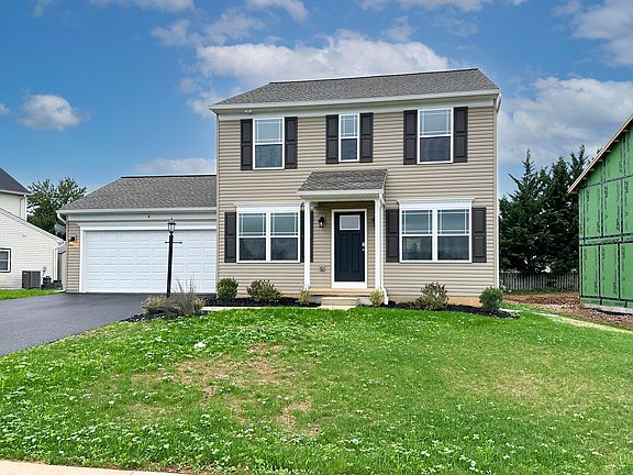 Exterior photo of a Chamberlain A - two story home with covered front entry and two car garage.