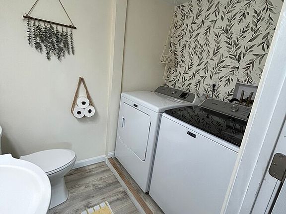 1/2 bathroom on first floor with laundry hook up. Dryer/washer is not included.